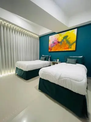 a bedroom with two beds and a painting on the wall at 2-2 Palmetto Eliptic 3403 Enchanted Jewel in Cartagena de Indias