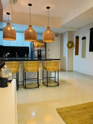 a kitchen with a bar with chairs and lights at 2-2 Palmetto Eliptic 3403 Enchanted Jewel in Cartagena de Indias