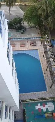 an overhead view of a large swimming pool next to a building at Confort en la zona del Laguito in Cartagena de Indias