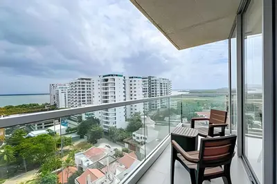 a balcony with two chairs and a table with a view at Apartamento 2 dormitorios Morros Vistas. Piscina in Cartagena de Indias