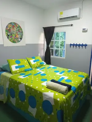 a bedroom with a bed with a polka dot blanket at Hotelito La Aventura, AC private WC rooms near the old town, no tax in Cartagena de Indias