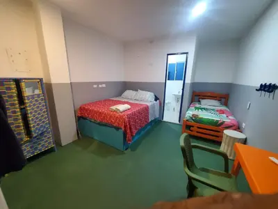 a small room with a bed and a mirror at Hotelito La Aventura, AC private WC rooms near the old town, no tax in Cartagena de Indias