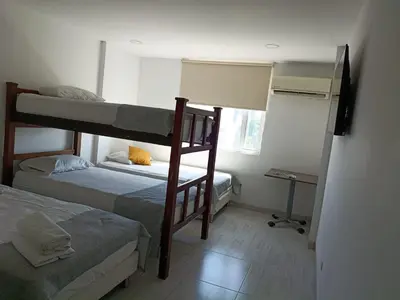 a room with two bunk beds and a desk at Hotel Doral Barranquilla in Barranquilla