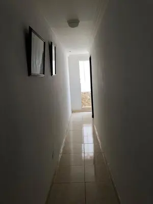 a hallway with two pictures on the wall and a window at Apartamentos y habitaciones cerca a marbella in Cartagena de Indias