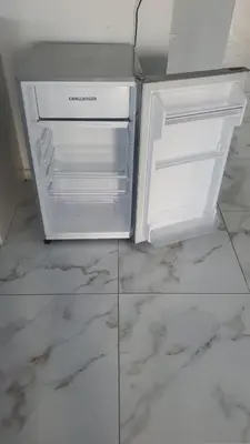 a white refrigerator with its door open on a marble floor at Apartamentos y habitaciones cerca a marbella in Cartagena de Indias