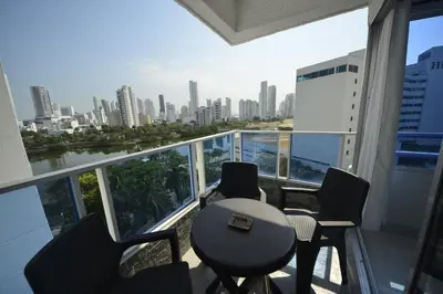 a balcony with a table and chairs and a city at Bienesweb Apartamentos Conquistador Premium in Cartagena de Indias