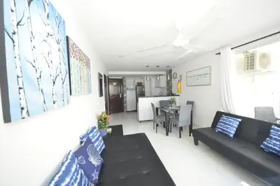 a living room with a black couch and a table at Bienesweb Apartamentos Conquistador Premium in Cartagena de Indias