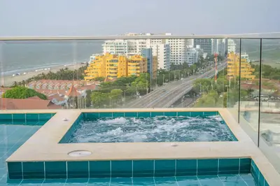 a swimming pool with a view of the ocean at 1H Encanto Rentals @ Sunno Beach in Cartagena de Indias