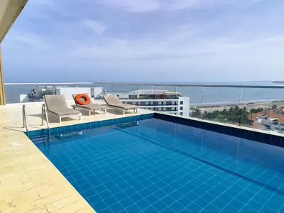 a swimming pool on the roof of a building at 1H Encanto Rentals @ Sunno Beach in Cartagena de Indias