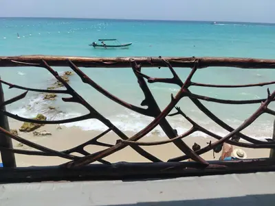 a view of a beach with a boat in the water at HOSTAL LAMAR BARU dónde Gertrudis in Playa Blanca
