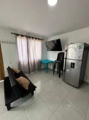 a living room with a couch and a refrigerator at Apto PB Palmar de los vientos in San Bernardo del Viento