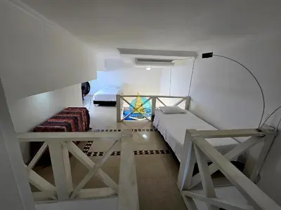 a small room with two beds and a table at Penthouse Duplex Vista 360 Piso 23 in Cartagena de Indias