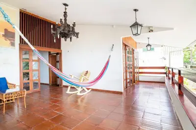a room with a hammock in a house at El Refugio Beach House, Bello Horizonte, Santa Marta in Playa Dormida