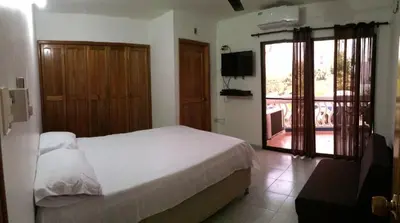 a bedroom with a bed and a balcony with a television at Apt 311 Mar de leva in Santa Marta