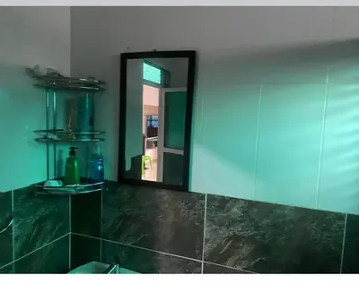 a bathroom with a mirror and a sink in it at Casa Murillo in San Antero