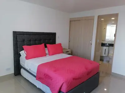 a bedroom with a large bed with red pillows at Apto 1715 in Cartagena de Indias