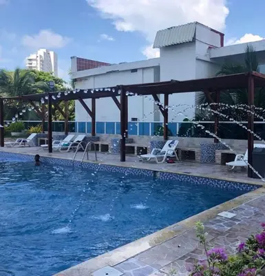 a pool at a hotel with a man in the water at Apto 1715 in Cartagena de Indias
