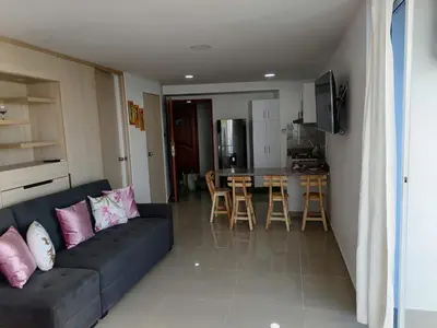 a living room with a couch and a kitchen at Apto 1715 in Cartagena de Indias