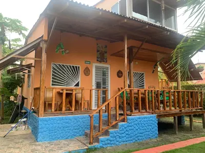 a house with a porch and a deck at Cabaña El Esplendor in San Bernardo del Viento
