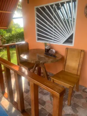 a dining room with a table and chairs and a window at Cabaña El Esplendor in San Bernardo del Viento
