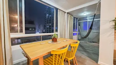 a dining room with a wooden table and yellow chairs at El Laguito Cartagena - Apartamento 2 habitaciones acceso directo a playa in Cartagena de Indias