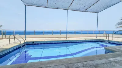 a swimming pool with a view of the ocean at El Laguito Cartagena - Apartamento 2 habitaciones acceso directo a playa in Cartagena de Indias