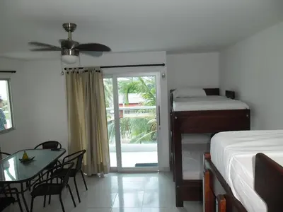 a bedroom with a bed and a table with a dining table at Villa Patry Coveñas in Coveñas