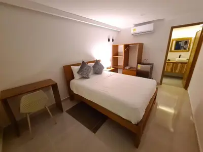 a bedroom with a bed and a bathroom with a sink at Villa Patry Coveñas in Coveñas