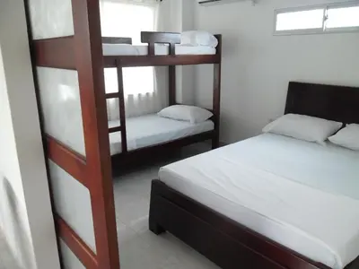 a bedroom with two bunk beds and a bed at Villa Patry Coveñas in Coveñas