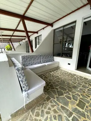 a white couch sitting on a patio at Cabañas La Española in Coveñas