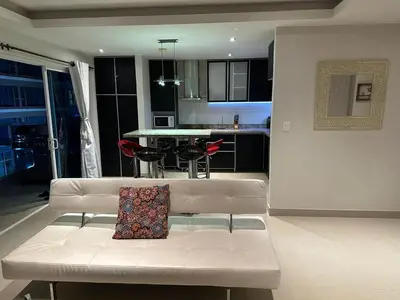 a white couch with a pillow on it in a living room at Sunshine 503 Beautiful SeaView 2Beds2bath w AC front Beach in Cartagena de Indias