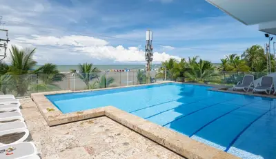 a swimming pool with a view of the ocean at Sunshine 503 Beautiful SeaView 2Beds2bath w AC front Beach in Cartagena de Indias