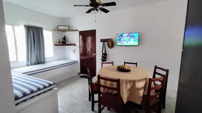 a dining room with a table and chairs and a window at Atardeceres Coveñas - Cabañas frente al mar in Puerto Viejo