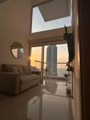 a living room with a couch and a view of the ocean at Luxury Sea View Duplex in the Heart of the City in Cartagena de Indias