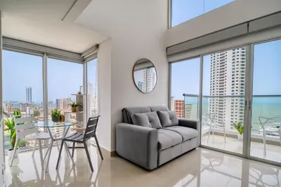 a living room with a couch and a table at Luxury Sea View Duplex in the Heart of the City in Cartagena de Indias