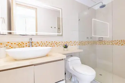 a bathroom with a sink and a toilet and a shower at U-GO Palmetto Beach - Lujo Frente al Mar in Cartagena de Indias