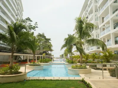 a swimming pool in the middle of a building with palm trees at Morros 3 in Cartagena de Indias