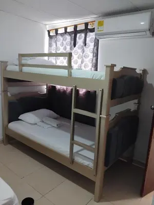 a bunk bed with a ladder in a room at Rosymar in Cartagena de Indias