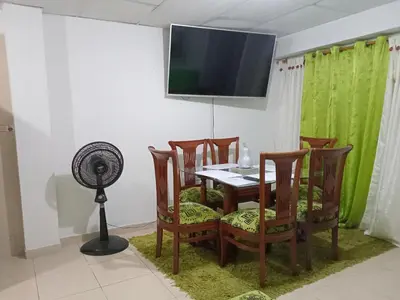 a dining room with a table with chairs and a fan at Rosymar in Cartagena de Indias
