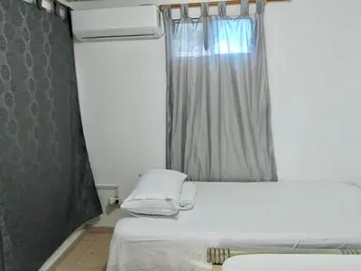 a small bedroom with a bed and a window at Rosymar in Cartagena de Indias
