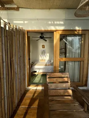 a bedroom with a bed and a ceiling fan at Cabaña Punta Coral in Rincón