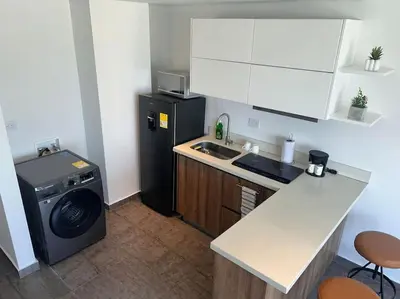 a kitchen with a washing machine and a washer at Apartamento Duplex en Barranquilla in Barranquilla