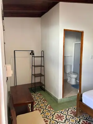 a room with a bathroom with a toilet and a table at Casa Belia in Cartagena de Indias