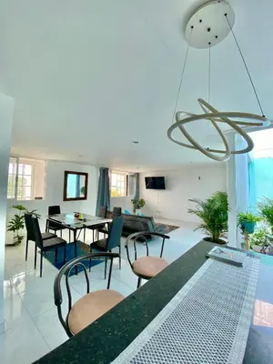 a living room with a table and chairs at Casa Jardin in Cartagena de Indias