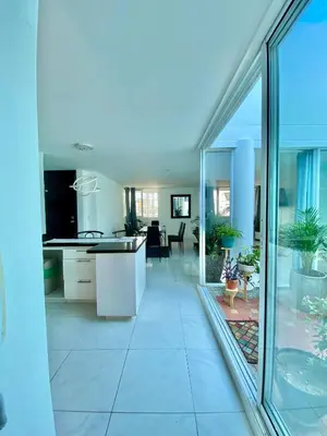 a kitchen and living room with a view of a living room at Casa Jardin in Cartagena de Indias