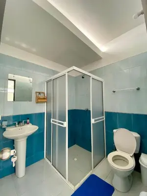 a bathroom with a shower and a toilet and a sink at Casa Jardin in Cartagena de Indias