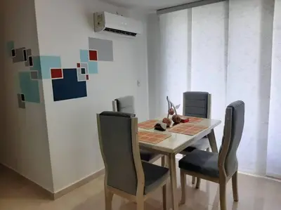 a dining room table with two chairs and a table and chairsktop at Apartamento familiar en Coveñas in Coveñas
