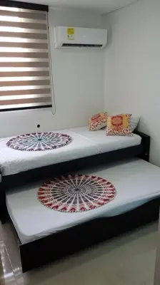 two bunk beds in a room with a window at Apartamento familiar en Coveñas in Coveñas