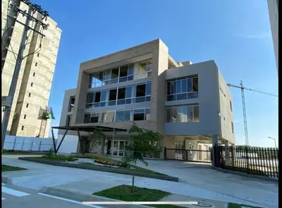a large building in front of a tall building at Apto nuevo al lado de la UNorte, 10 Min Buena vista Grav vista in Barranquilla