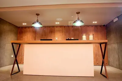 a large white counter in a room with two lights at GHL San Lazaro Art Hotel in Cartagena de Indias